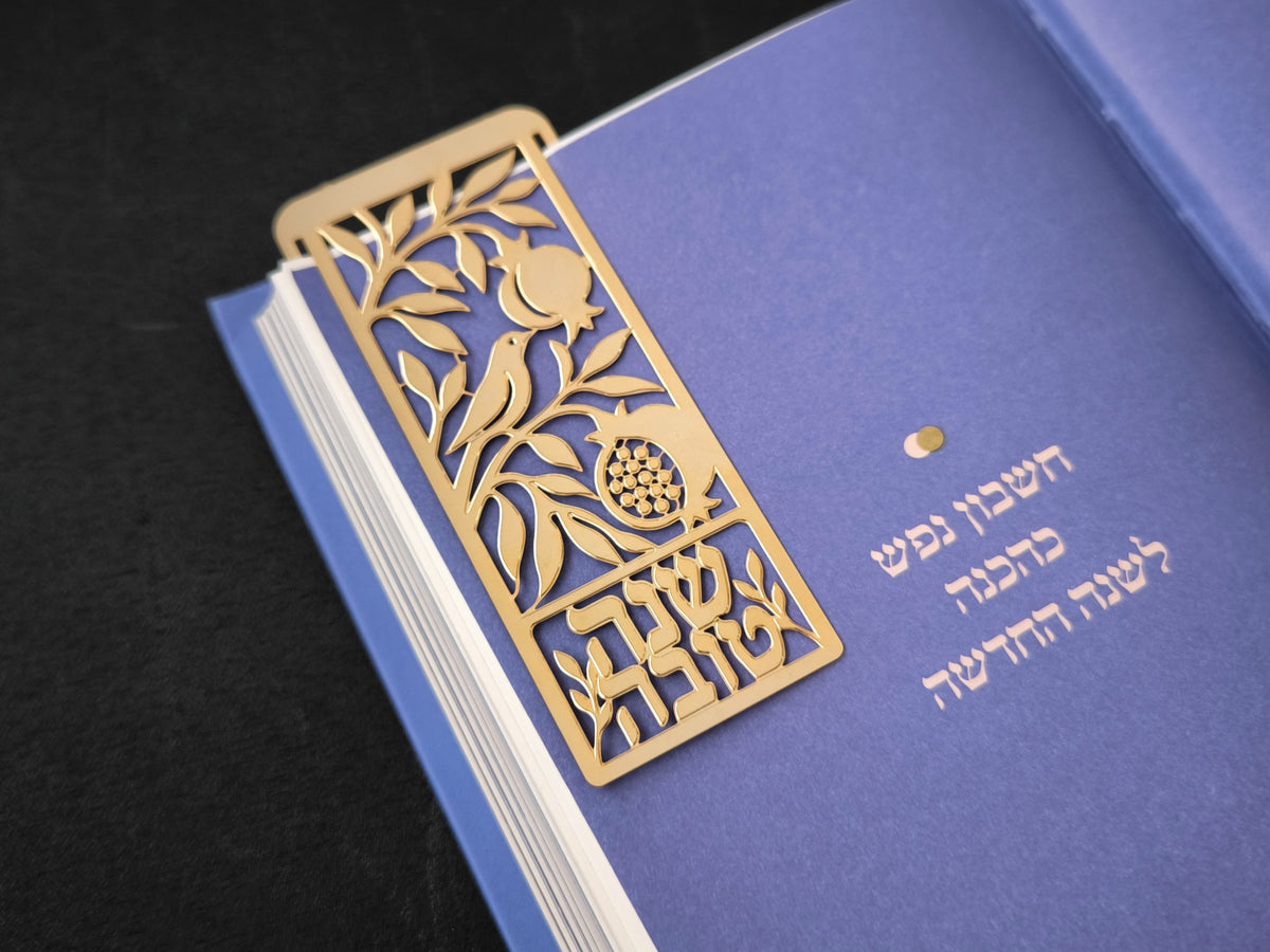 סימנייה בגוון זהב בעיצוב שנה טובה, מוצגת על ספר (1)